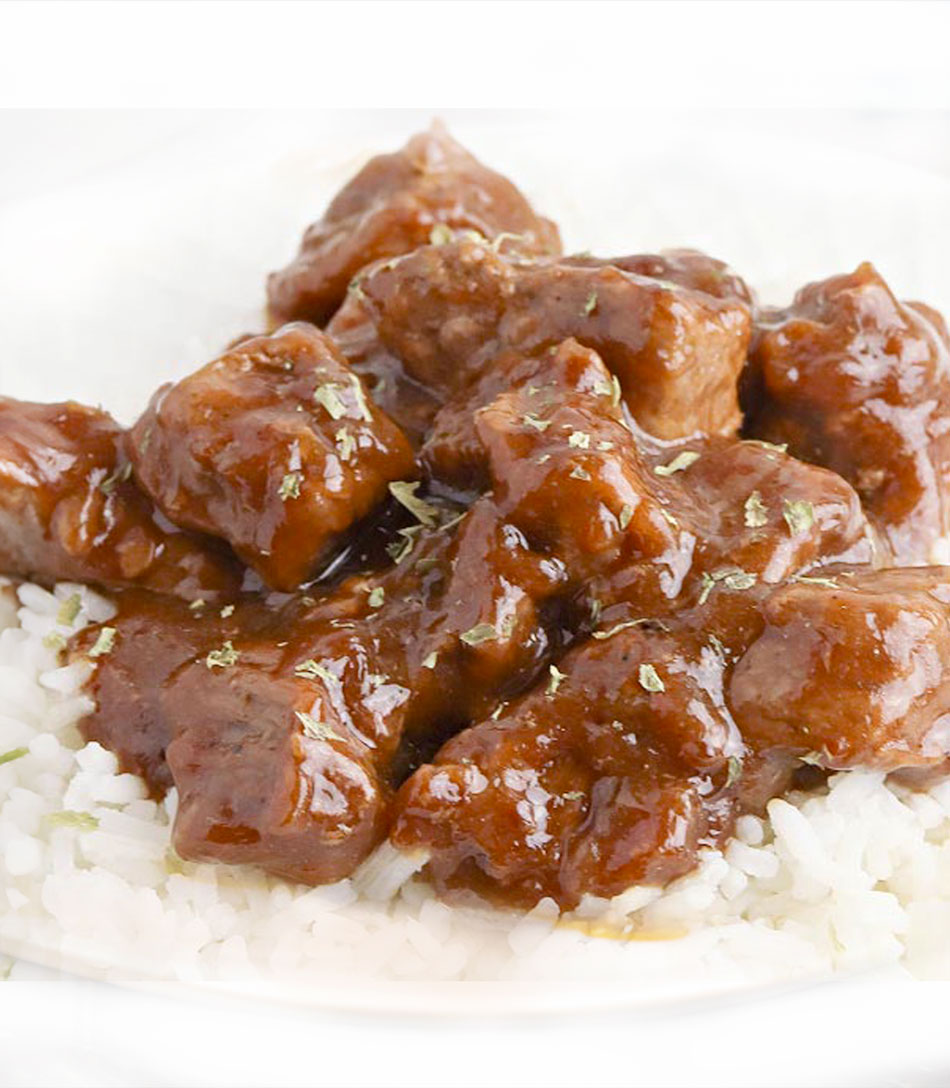 Enjoy our smothered beef tips, featuring tender chunks of beef slow-cooked in a rich gravy with onions and peppers for a hearty, flavorful dish.