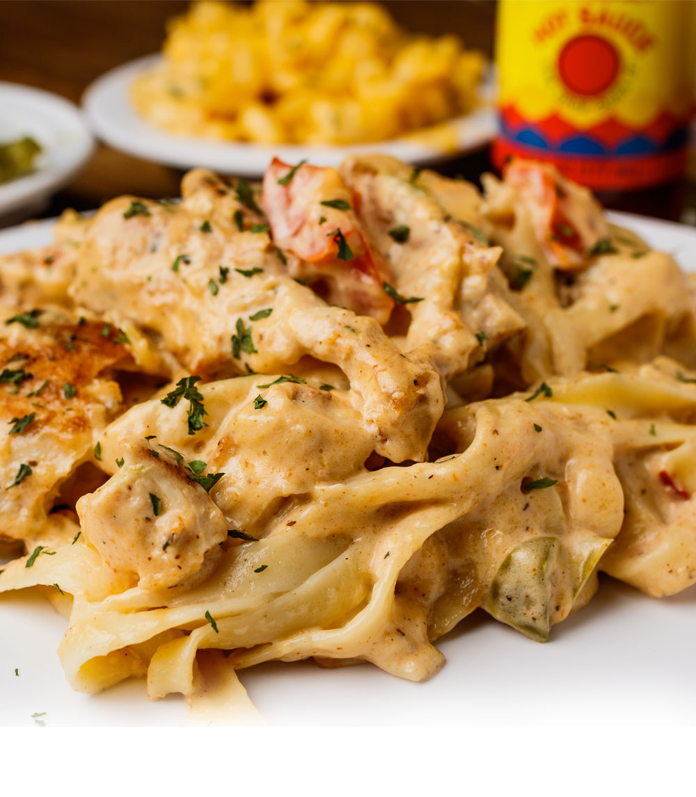 Delight in our chicken and shrimp fettuccine, a creamy pasta dish featuring tender chicken, succulent shrimp, and fettuccine tossed in a rich Alfredo sauce.
