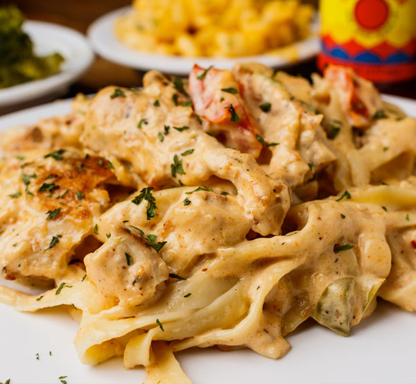 Delight in our chicken and shrimp fettuccine, a creamy pasta dish featuring tender chicken, succulent shrimp, and fettuccine tossed in a rich Alfredo sauce.