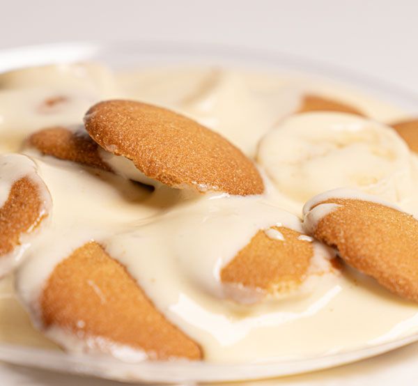 Layered banana pudding with creamy custard, fresh bananas, and vanilla wafers.