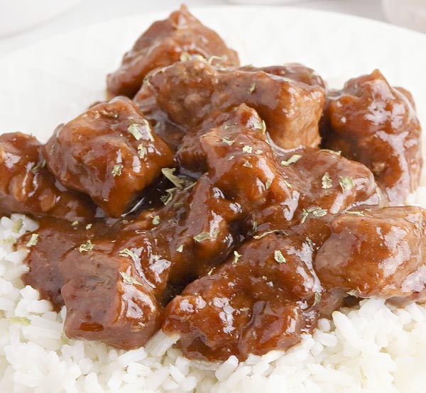 Enjoy our smothered beef tips, featuring tender chunks of beef slow-cooked in a rich gravy with onions and peppers for a hearty, flavorful dish.