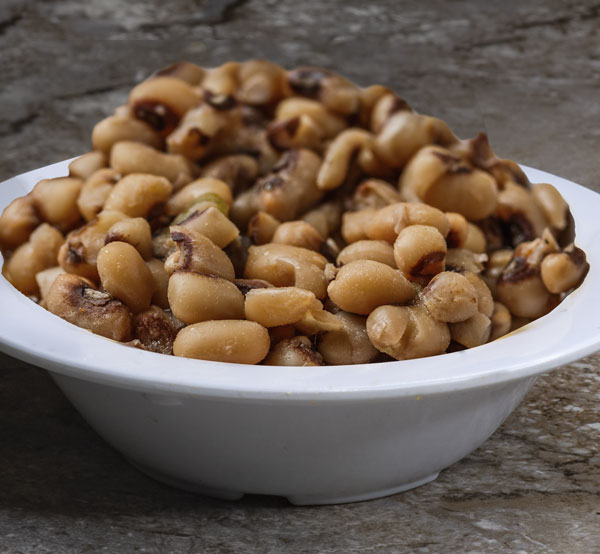 Enjoy a bowl of black-eyed peas, slow-cooked with spices and smoky flavors for a comforting and nutritious dish often enjoyed on New Year's Day for good luck.