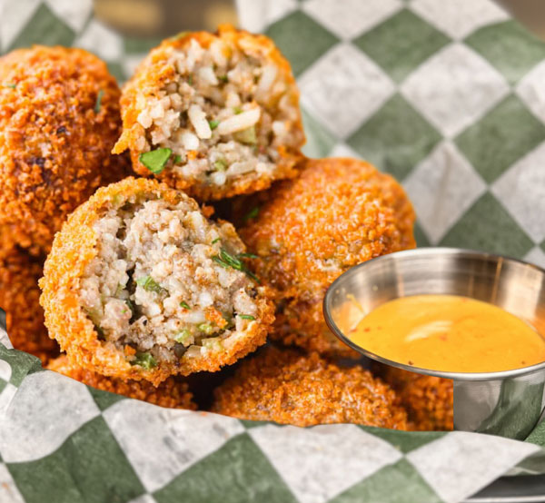 Crispy boudin balls, filled with flavorful boudin sausage and served with a zesty dipping sauce.