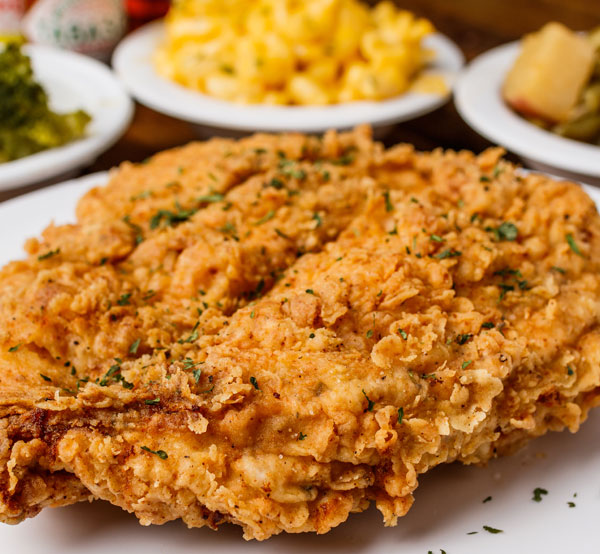 Indulge in our chicken fried chicken, featuring crispy fried chicken breasts smothered in creamy gravy for a soul-satisfying dish.