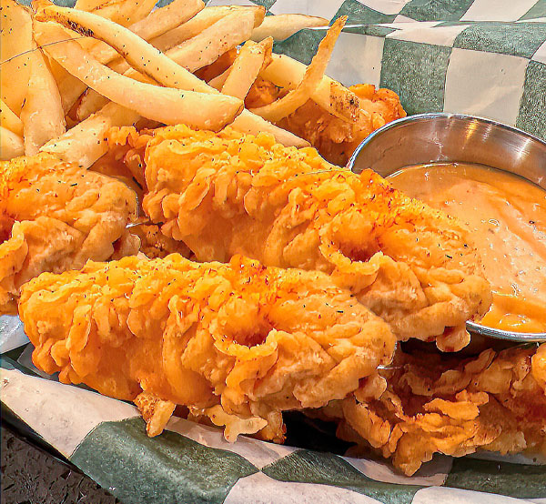 Crispy chicken strips served with golden fries, creating a satisfying and hearty meal.