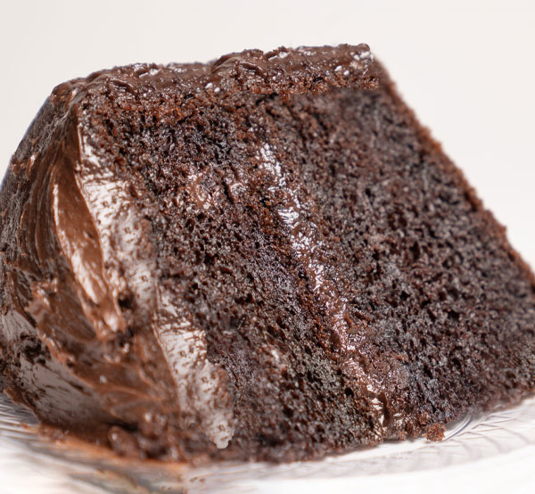 Rich and moist chocolate cake layered with chocolate frosting, perfect for chocolate lovers!