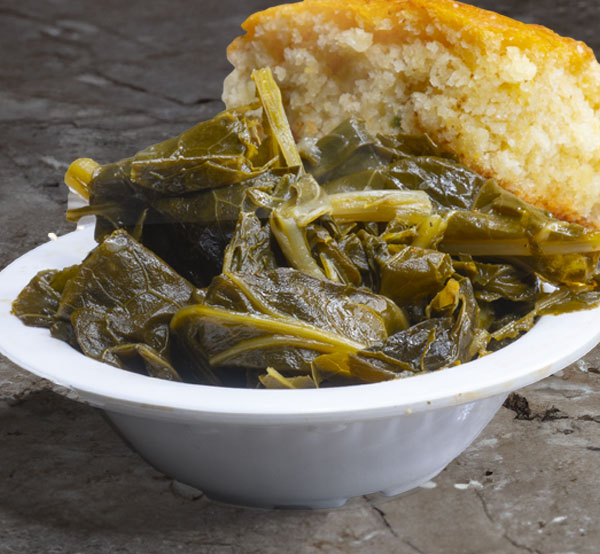 Enjoy our collard greens, slow-cooked to tender perfection with smoked meat and spices, offering a true taste of Southern tradition.