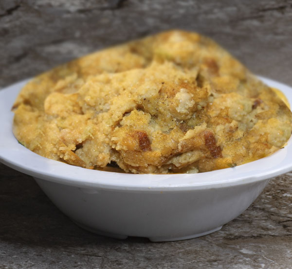 Indulge in cornbread dressing, a savory blend of crumbled cornbread, aromatic herbs, and vegetables, baked to golden perfection.