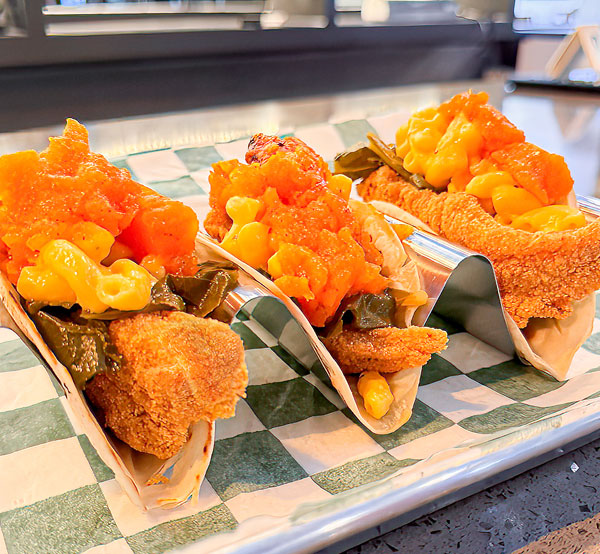 Flavorful catfish tacos served with a side of collard greens, yams, and creamy mac & cheese.