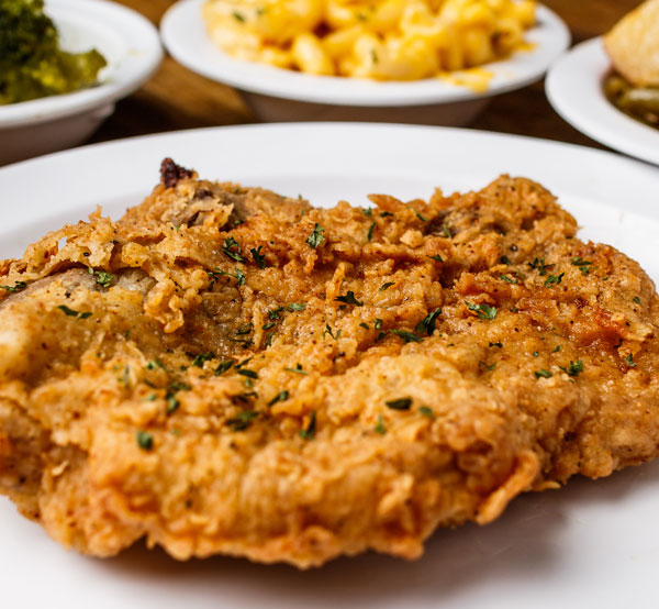 Savor our fried pork chops, perfectly seasoned and fried to a crisp golden brown, delivering a mouthwatering crunch with every bite.