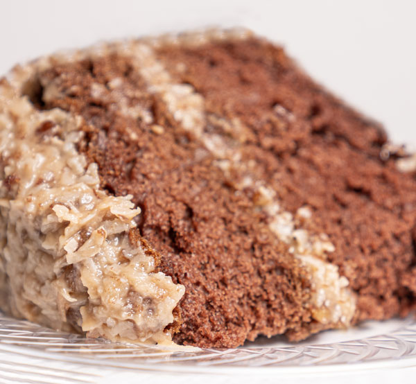 German chocolate cake layered with rich chocolate, coconut, and pecan frosting for a deliciously unique dessert.