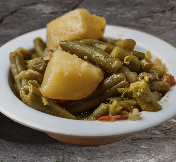 Savor the comfort of our green beans with bacon and potatoes, a hearty side that brings together the perfect blend of flavors in every bite.
