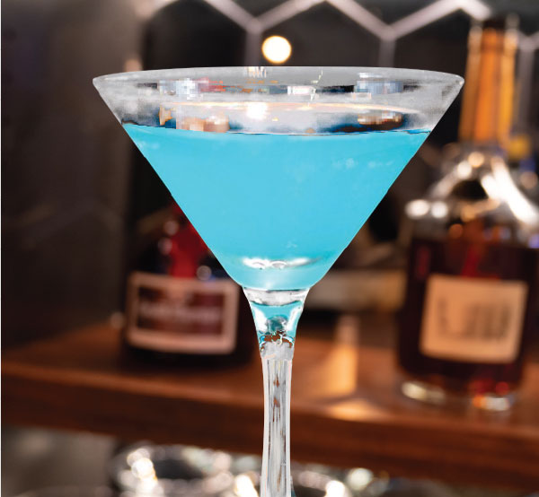 A vibrant Hypnotic cocktail made with tequila, triple sec, and pineapple juice, creating a tropical escape in a glass.