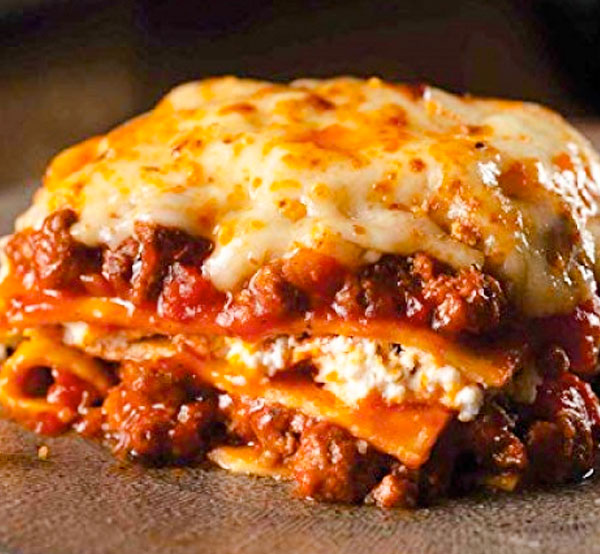 Indulge in our hearty beef lasagna, layers of tender pasta, rich meat sauce, and melted cheese baked to perfection for a comforting and satisfying meal.