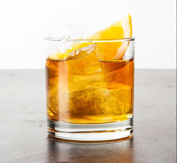 A classic Old Fashioned cocktail made with bourbon, sugar, bitters, and an orange twist, served on the rocks.