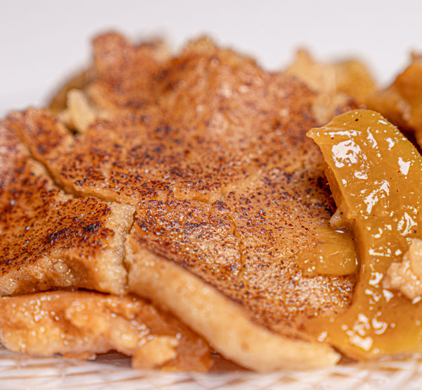 Delight in our classic peach cobbler, featuring ripe, juicy peaches layered beneath a golden, buttery crust, offering a warm and comforting dessert straight from the oven.