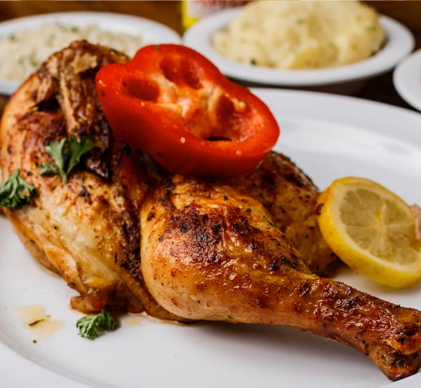Savor our roasted chicken, perfectly seasoned and baked to golden brown, delivering juicy meat and crispy skin that embodies Southern comfort.