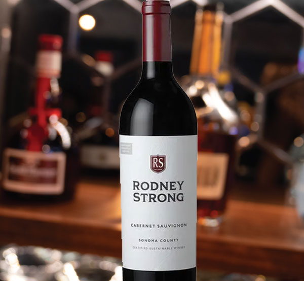 A bottle of Rodney Strong wine, featuring its distinctive label and deep hues, ready to complement your dining experience.