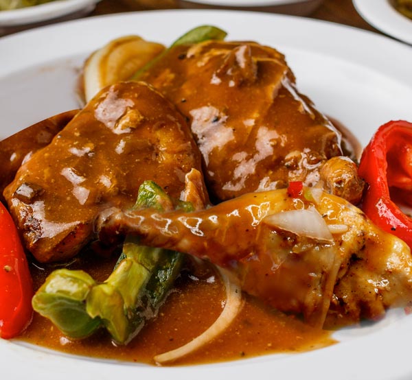 Enjoy our smothered chicken, featuring tender pieces of chicken cooked in a rich, savory gravy that’s perfect for soaking up with your favorite sides.