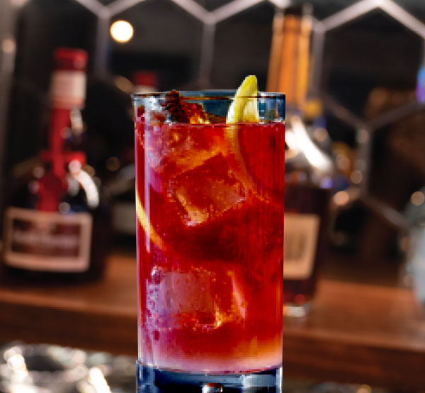 A refreshing Spiked Raspberry Tea cocktail made with vodka, gin, tequila, rum, and Mikki's signature raspberry tea.
