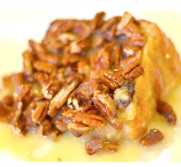 bread pudding made with rich white chocolate, topped with a creamy rum sauce & pecans—comfort food at its best!
