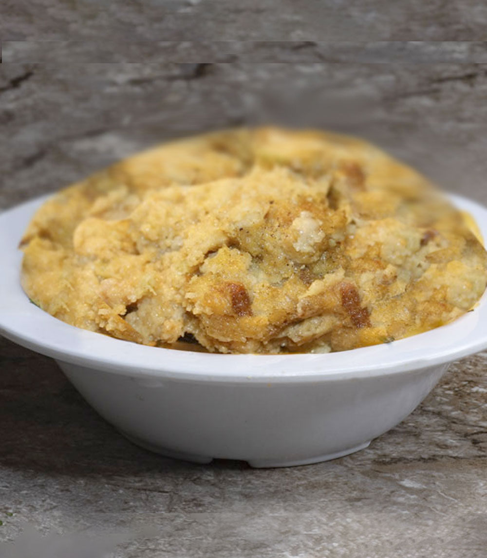 Indulge in cornbread dressing, a savory blend of crumbled cornbread, aromatic herbs, and vegetables, baked to golden perfection.