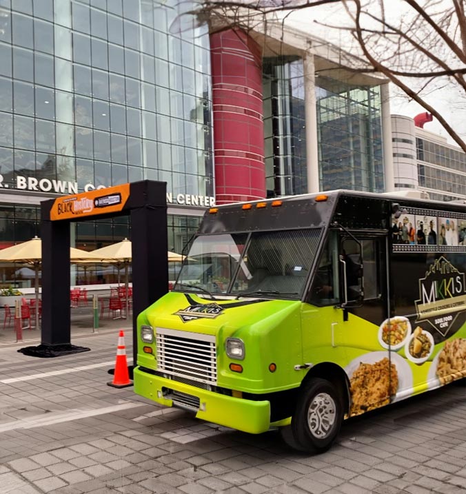 Mikki's Cafe food truck serving delicious soul food dishes to customers at an outdoor event.