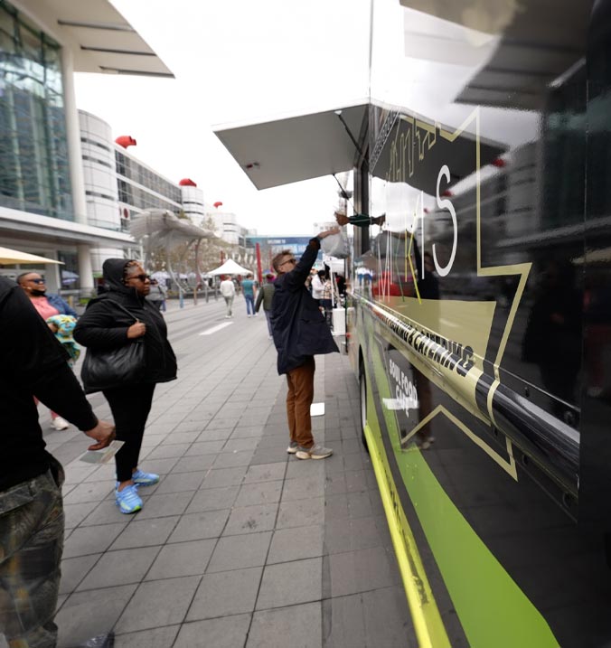 Mikki's Cafe food truck serving delicious soul food dishes to customers at an outdoor event.