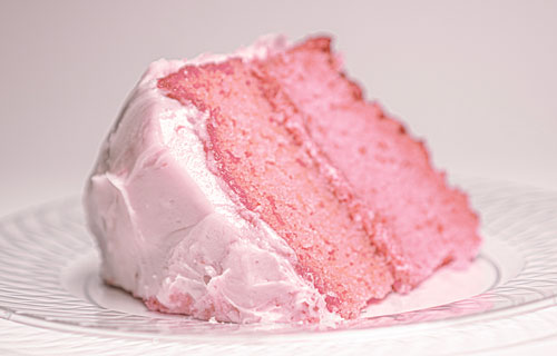 Moist strawberry cake layered with fresh strawberries and fluffy whipped cream, beautifully presented for a delightful dessert experience.